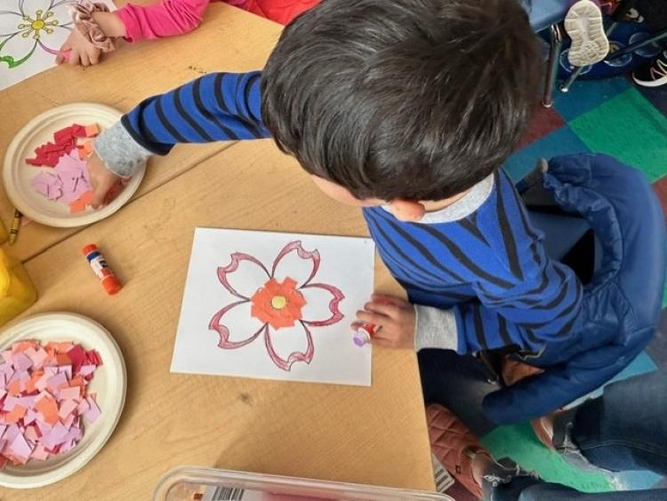 Elementary age student works on a paper craft in the classroom