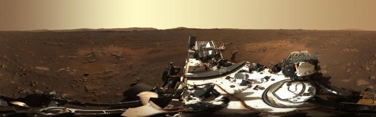 A panorama of the Martian landscape with part of the Perseverance rover in the foreground