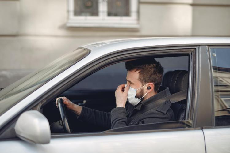 Man driving with mask