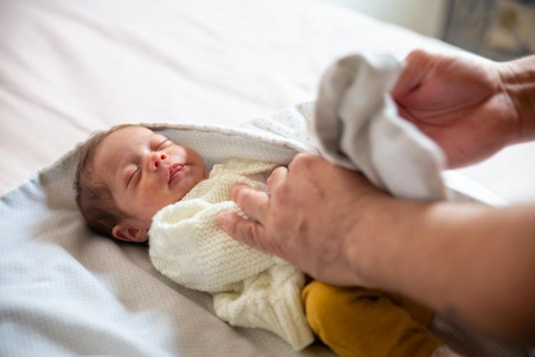 dad wrapping baby in a blanket