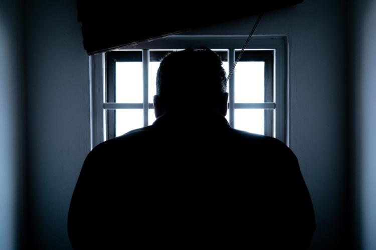 A shadowed image of a prisoner
