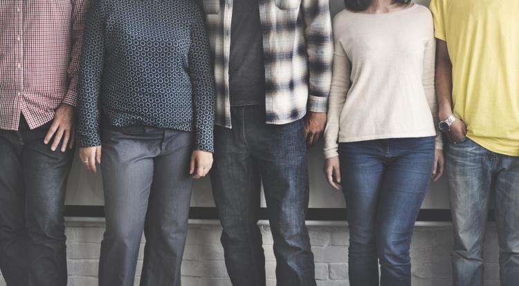 Group of young, diverse people stand side-by-side