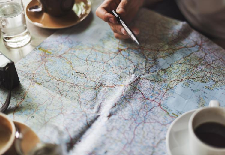 People look at map while drinking coffee