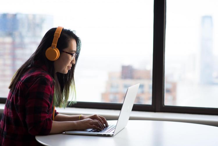 person wearing headphones at computer