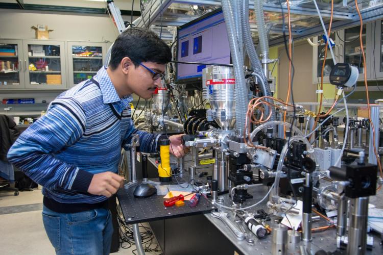 Physics student works in lab.