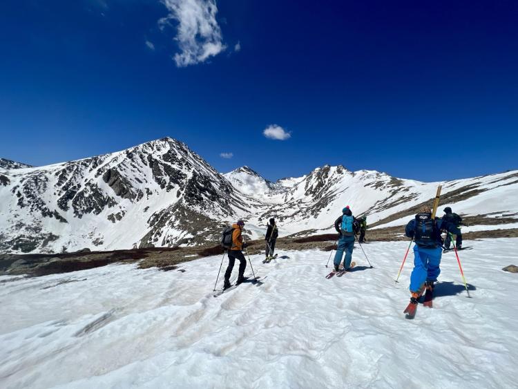 Researchers on skis collect snow measurements near the Continental Divide in Colorado