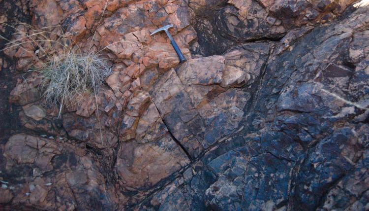 Rock formation with a hammer for scale.