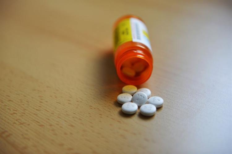 Prescription pills spilling out onto table
