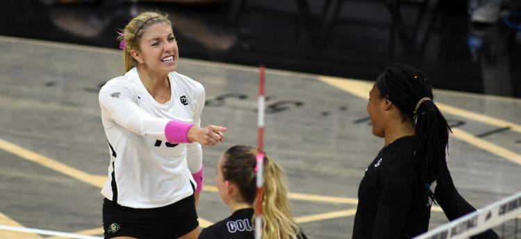 A CU volleyball player wears pink during a match