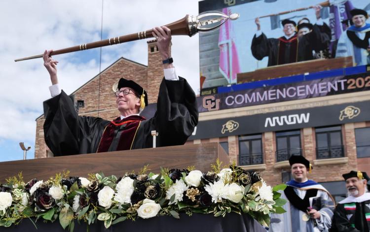 Bud Coleman holds the mace during the 2022 commencement ceremony