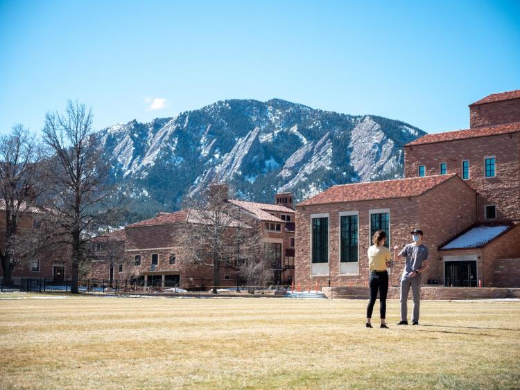 students talking outside on campus