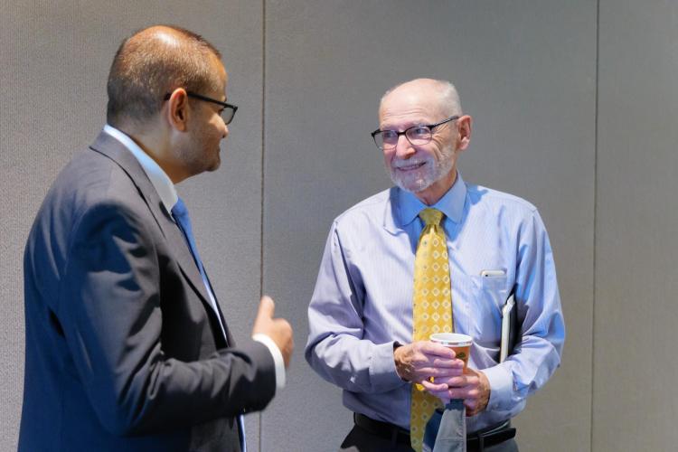 Provost Russell Moore speaking with Leeds School of Business Dean Vijay Khatri