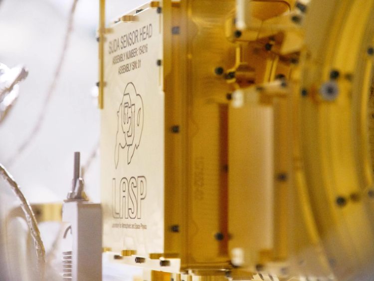 Golden panel on a space instrument with an image of a buffalo and the word "LASP"