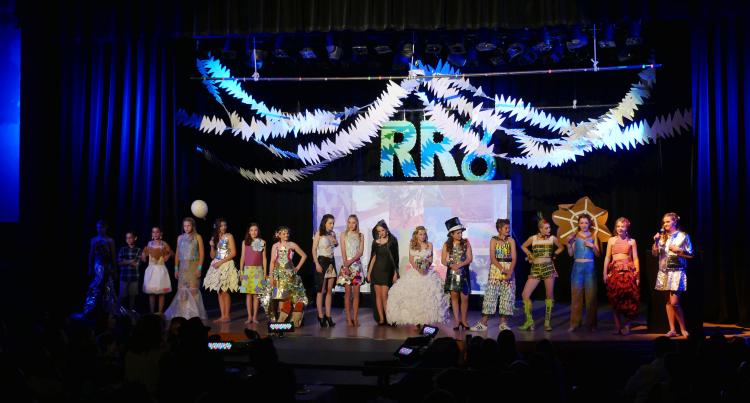 Recycled runway participants line up on stage