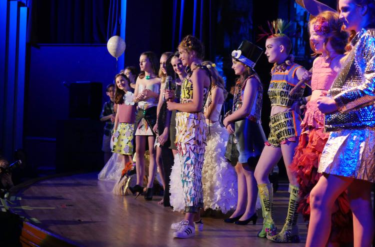 Recycled runway participants line up on stage