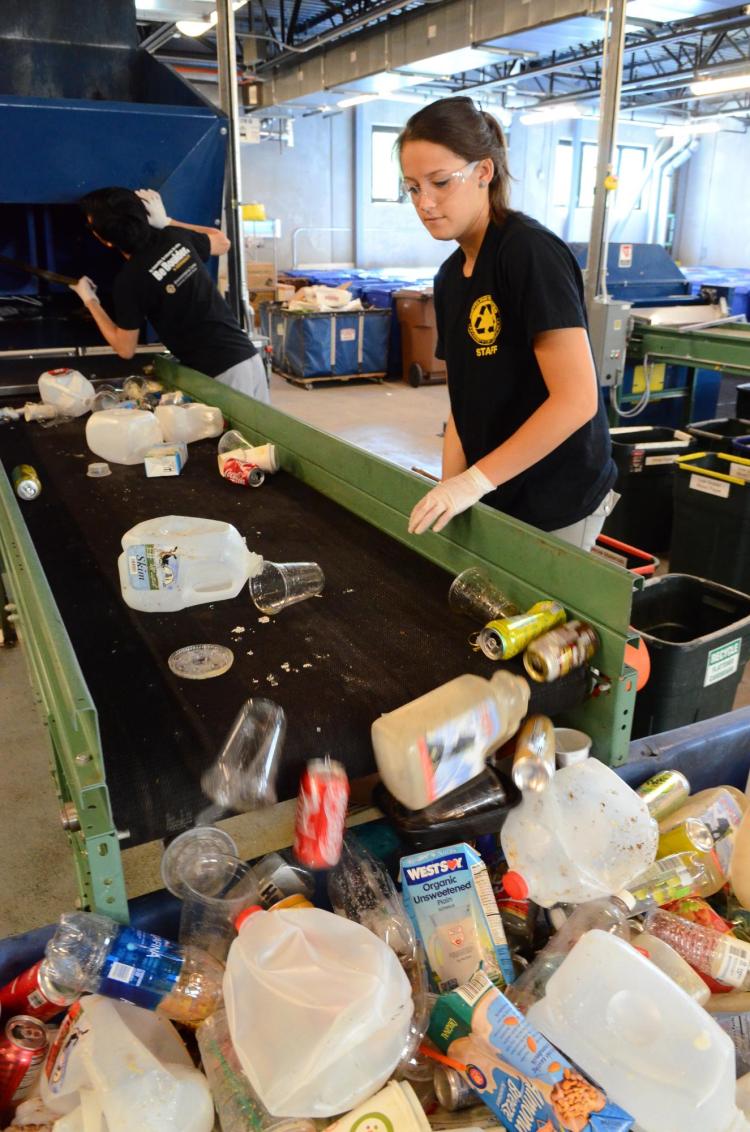 Students sort through recycled material in the Recycling Center at CU Boulder