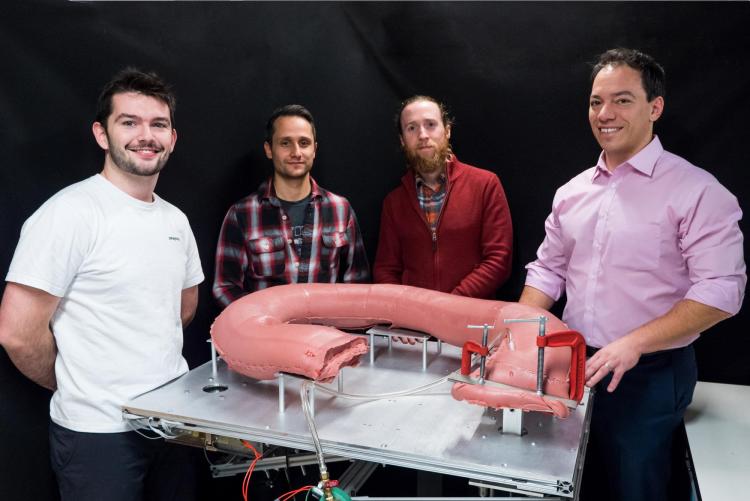Mark Rentschler stands in front of a large artificial colon.