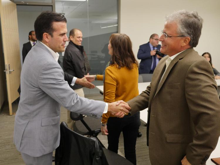 Governor Ricardo Rossello shakes hands with Assistant Vice Chancellor Dave Aragon, photo by Casey A. Cass