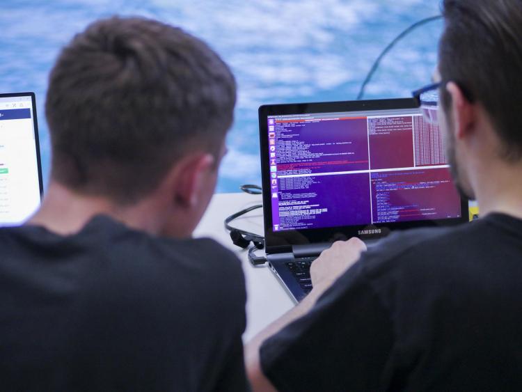 Students review information received from the RoboSub.