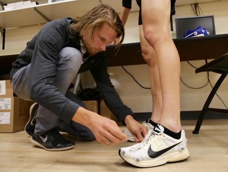 Wouter Hoogkamer places sensors on running shoes