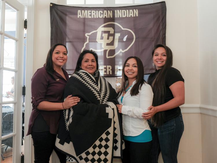 Patrita “Ime” Salazar wears a ceremonial “Los Ojos” wool blanket as she poses with her daughters, left to right, Kalee, Tachara and Cibonet.