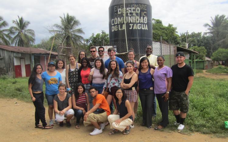 A group of students and faculty pose for a photo in Haiti