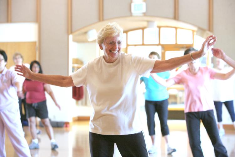 Senior woman exercising in group class