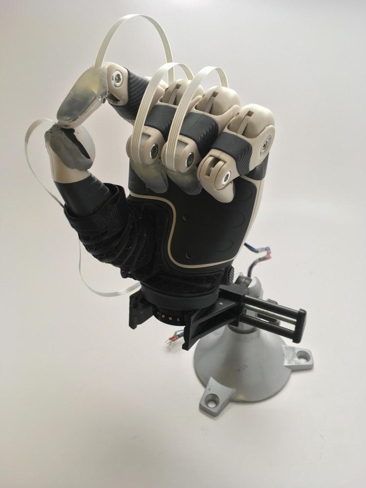 A prosthetic hand with fingertip sensors installed.