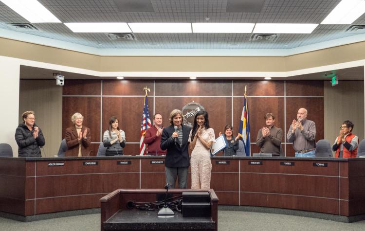 CU Boulder journalism and political science undergraduate student and Rhodes Scholar Serene Singh, right, gets a standing ovation after Boulder Mayor Suzanne Jones read a special proclamation honoring her at the Boulder City Council chambers on December 4, 2018 before their regular weekly meeting. (Photo by Glenn Asakawa/University of Colorado)