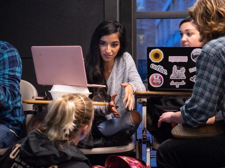 Serene Singh works with fellow classmates in a poli sci thesis class