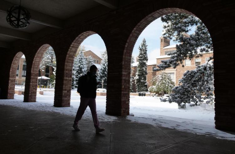 Student walking on snowy campus