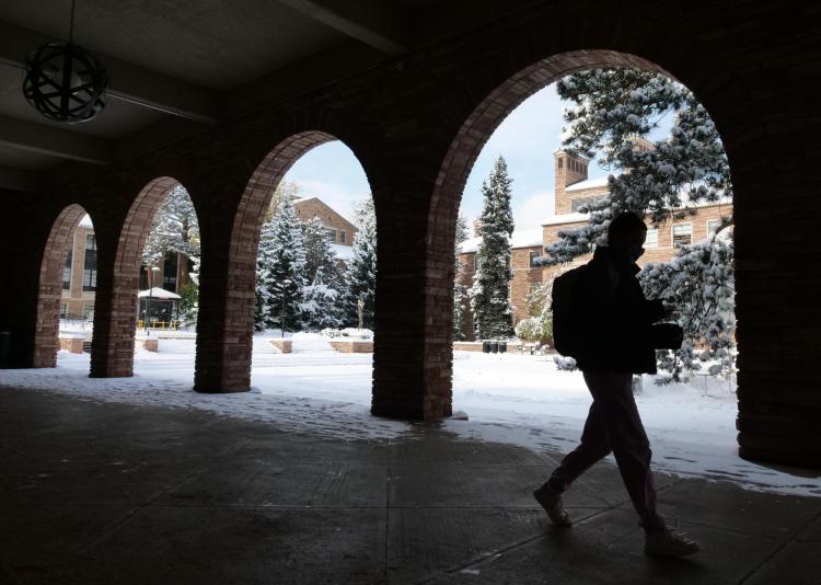 person walking on snowy campus
