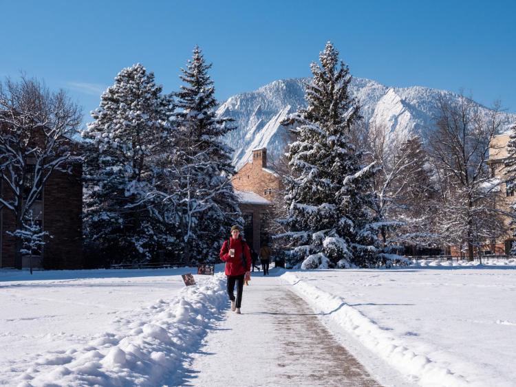 Student walking on snowy campus