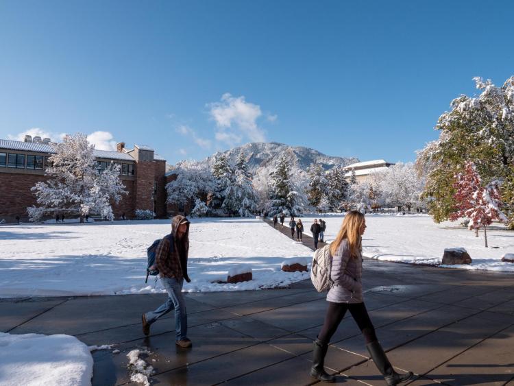 students walking on a snowy campus