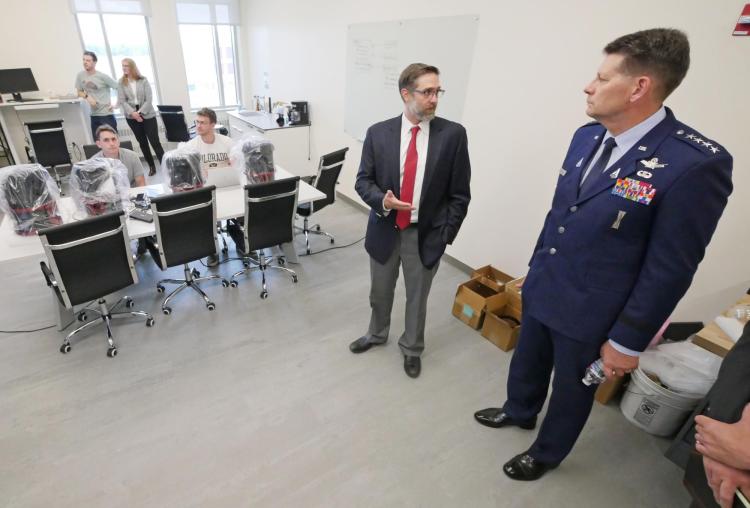 Gen. Thompson speaks to Professor Marcus Holzinger in his lab on campus