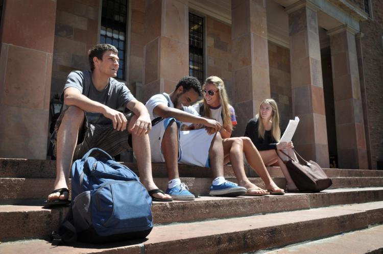 Students sitting on the steps of Norlin Library