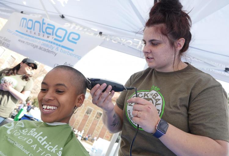 First-year student Asha Romeo donates her hair. Photo by Casey A. Cass.
