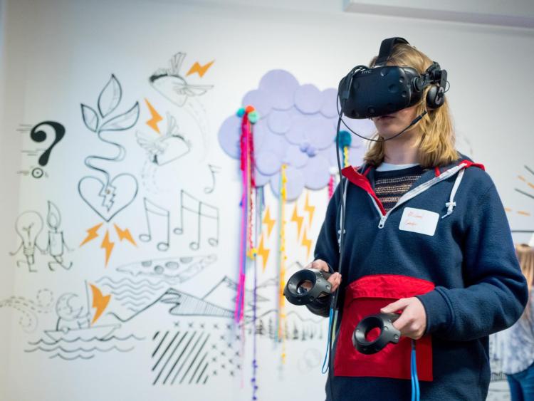 Student watches VR at the Startup Hub grand opening event. Photo by Patrick Campbell.