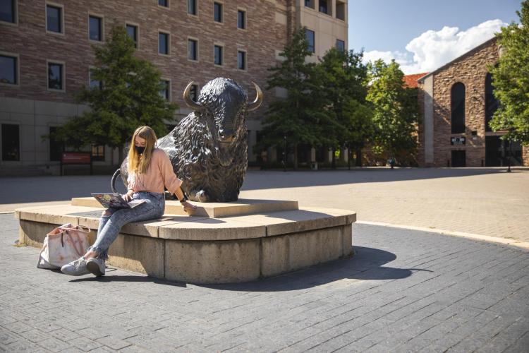 student wearing mask on campus