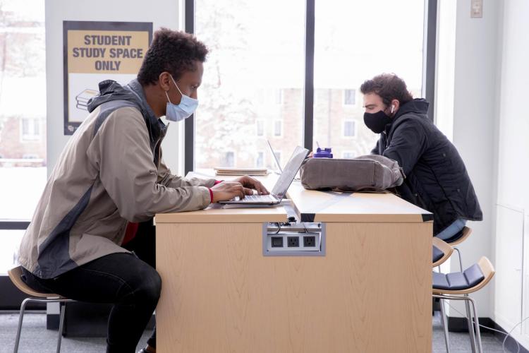 Students at the Leeds School of Business studying indoors.