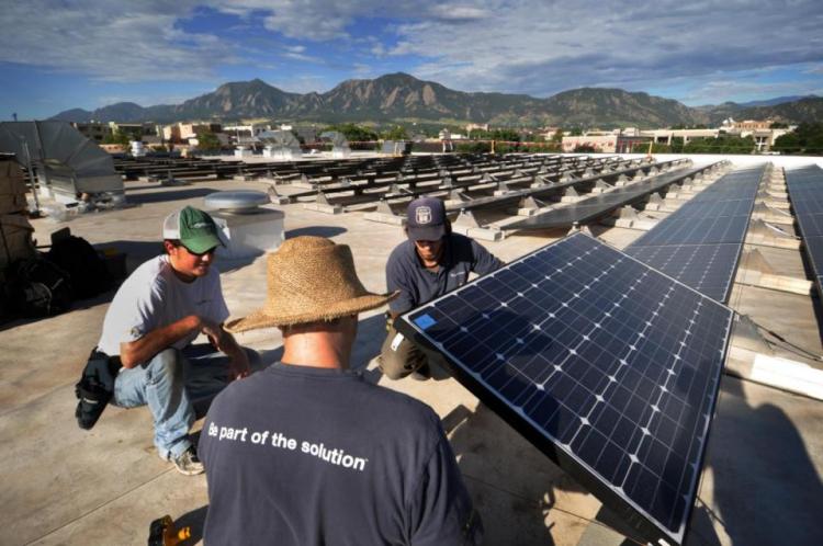 CU staff members install solar panels on campus
