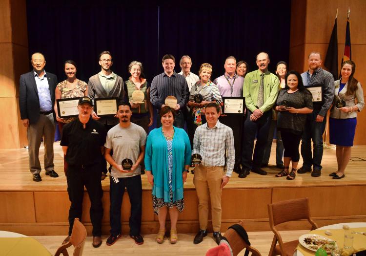 The campus sustainability award winners stand shoulder to shoulder.