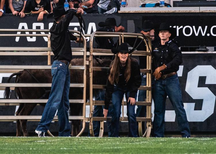Taylor Stratton, center, getting ready to open the gate for Ralphie VI's inaugural run.