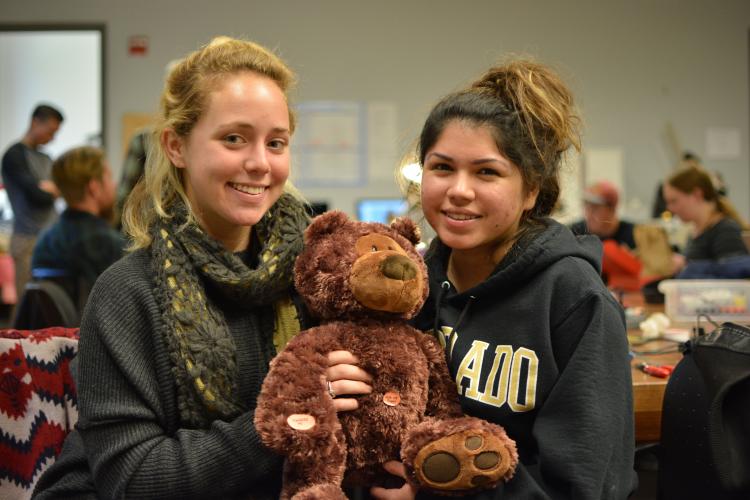 Marla Bernstein and Carolyn Castanon, hold their teddy bear, "Chill Out Carly"between them.