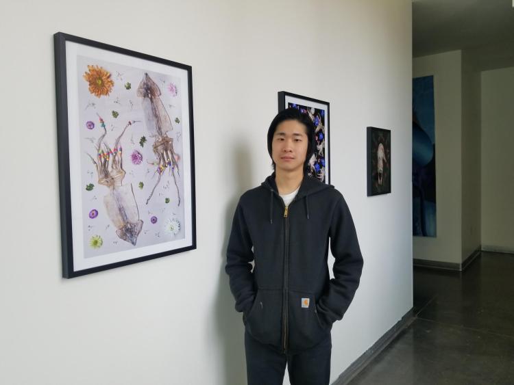 Thomas Yi with his framed food photography