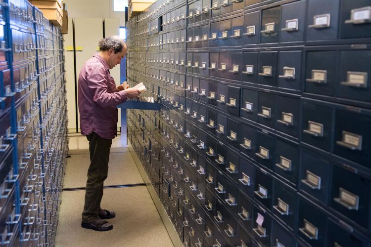 Tim Clark looks through file drawers