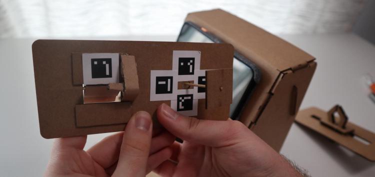 Shot of the back of a Tinycade controller with digital markers printed out on paper