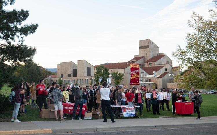 Peaceful protesters gather outside; photo by Glenn Asakawa