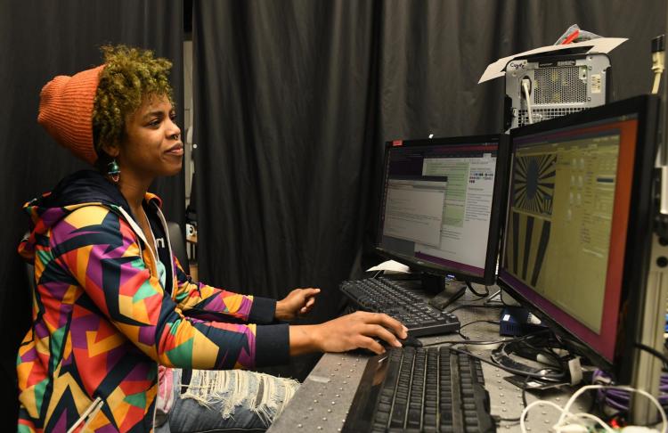 Shaz Zamore analyzing data on a computer