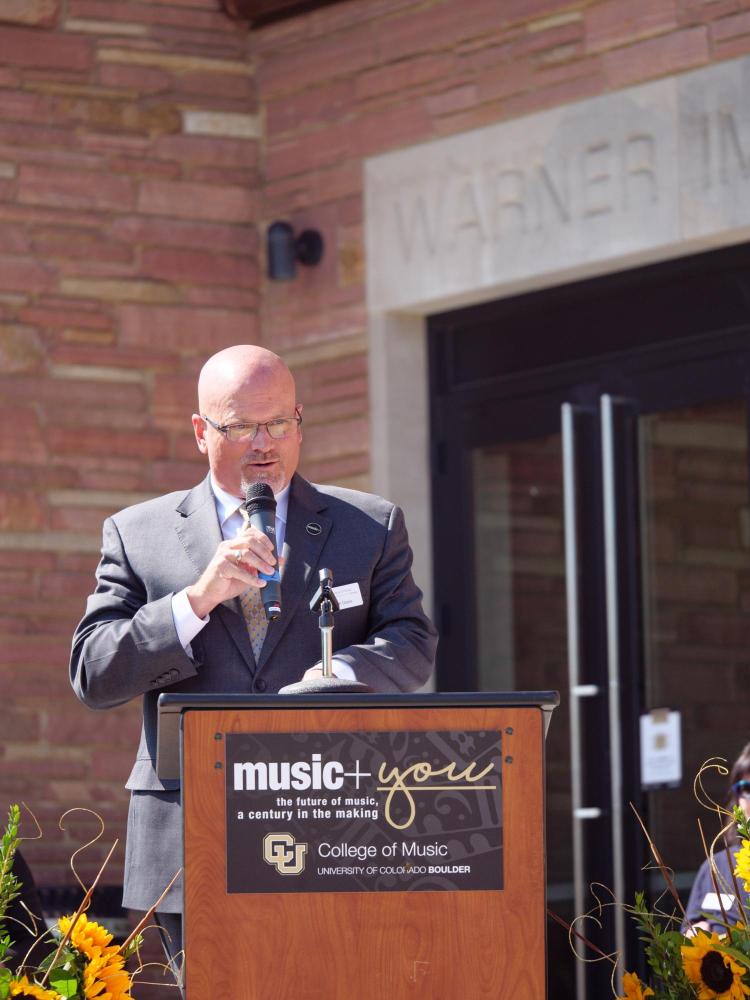 CU Boulder College of Music Dean John Davis addresses campus, CU system and College of Music faculty, leadership, guests, donors, alumni and other dignitaries gather for the official ribbon cutting and opening of the Warner Imig Music building expansion on Sept. 17, 2021. (Photo by Glenn Asakawa/University of Colorado)